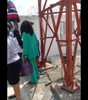 Viral video shows bank employees scaling a fence to avoid angry customers.